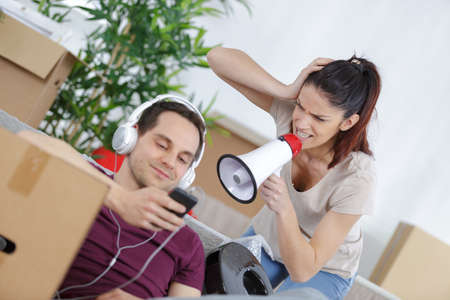 young woman threatening husband at homeの写真素材