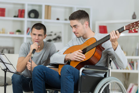 friends playing music, one in wheelchair