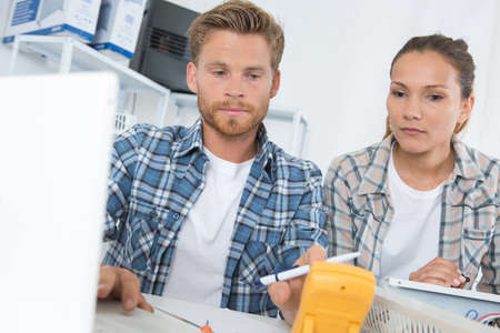 electromechanical assembler looking the the voltmeterの写真素材