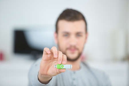 man with a green usb penの写真素材