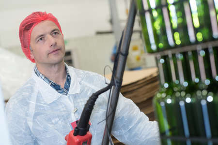 man working in a wineryの写真素材