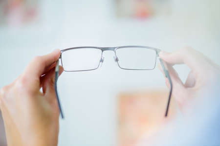 holding a pair of glassesの写真素材