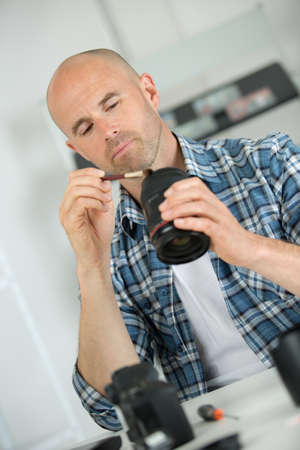 cleaning the fragile camera lensの写真素材