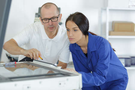 young apprentice listening to her teacherの写真素材