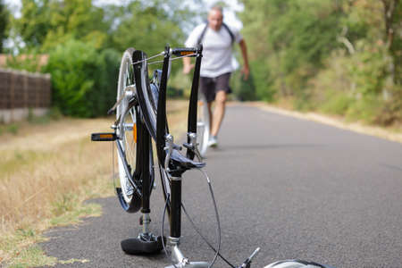 man responding to a bike accidentの写真素材