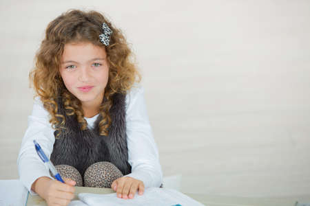 young girl doing her assignmentの写真素材