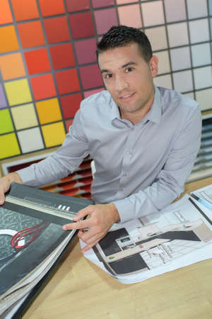 Portrait of man in decorators shopの写真素材