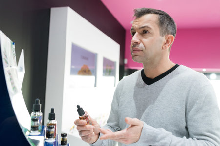 man asking for a refund in an e-cigarette shopの写真素材