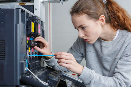 Technician working on photocopierの写真素材