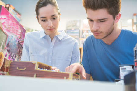 couple shopping in computer game shopの写真素材