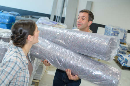 workers of a warehouse transporting plastic packagingの写真素材