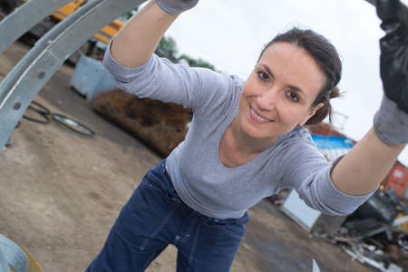 female worker conversing in shipping yardの写真素材