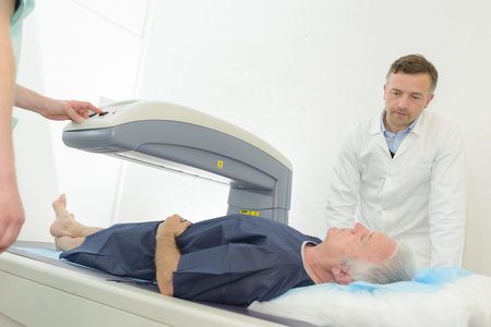 doctor sets up machine to x-ray a patient