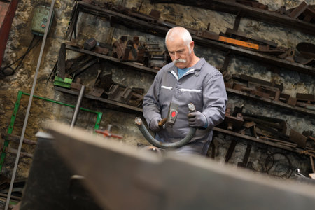 older male steel worker with protective glasses