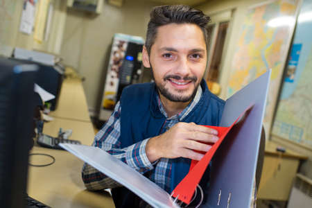 man smiling with the folder of documentsの写真素材