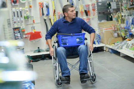 man in wheelchair shoppingの写真素材