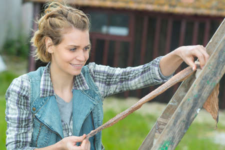 happy female gardener outside greenhouseの写真素材