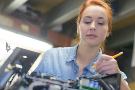 young female mechanic in garageの写真素材
