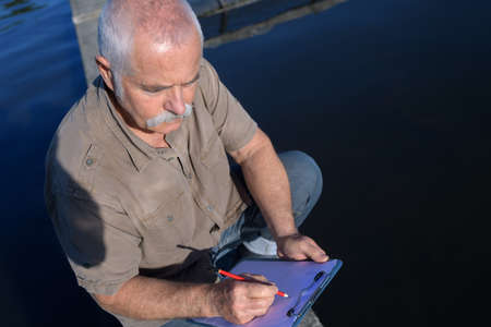 worker writing on the clipboardの写真素材
