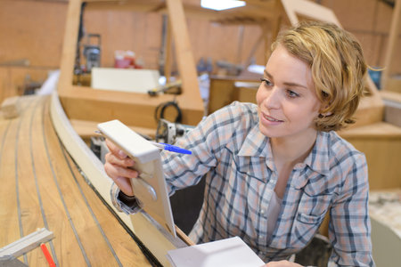 woman working in a boat workshopの写真素材