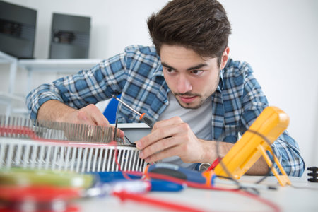 young man repairing radiator