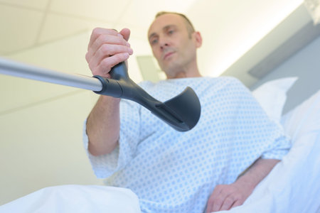 patient holding the crutches