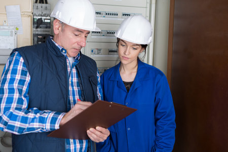 fully-fledged electrician and female apprentice