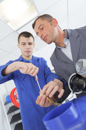 apprentice being supervised by the teacherの写真素材