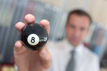 player holding a billard 8-ball