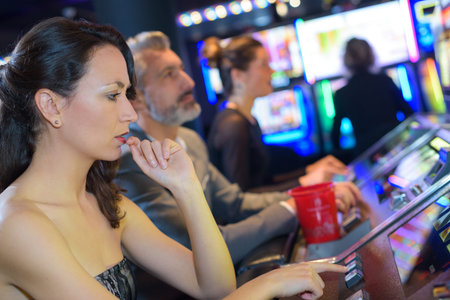 couple playing together at slot machine