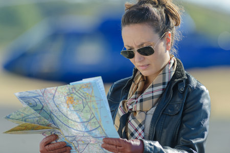 woman checking the map in the tarmacの写真素材