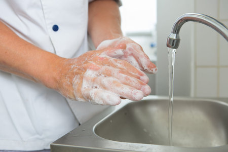 close up of medical staff washing hands