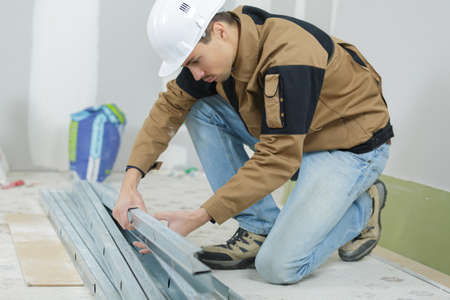 young metalworker choosing some metal barsの写真素材