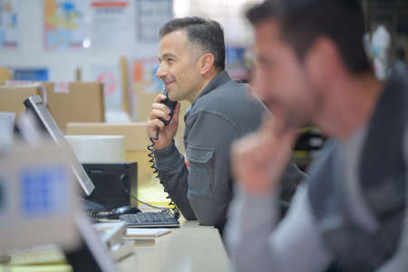 warehouse manager on the phone in a warehouseの写真素材