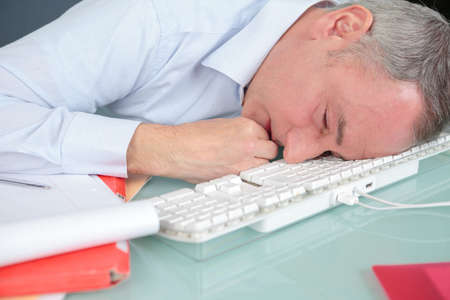 Businessman sleeping in the officeの写真素材