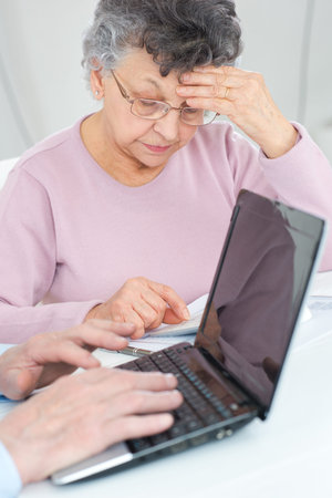A senior couple calculating taxes at home