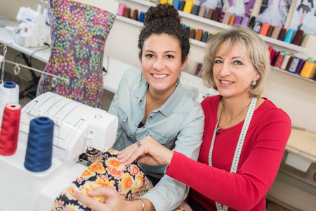 two dressmaker looks at a nice sweater in their workshop
