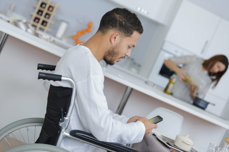 young man in wheelchair with his girlfriendの写真素材