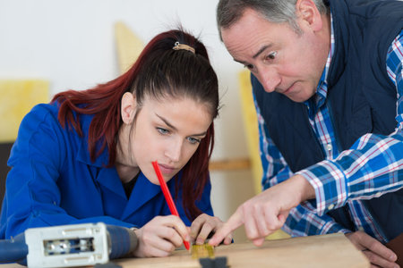 young carpenter marking the plywood