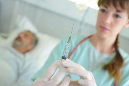 nurse filling the medical syringeの写真素材