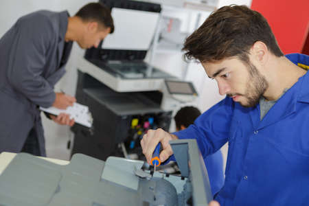 modern printing machine operator and apprenticeの写真素材