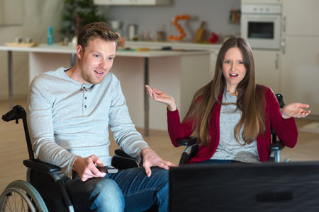 couple watching tv in the living room at home