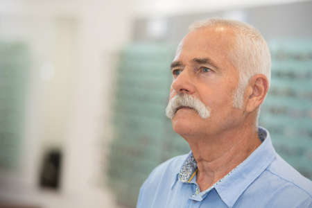 senior male client choosing spectaclesの写真素材