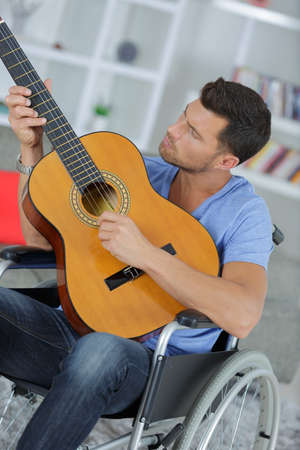 talented disabled man playing guitarの写真素材