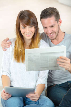 couple happy with the news on the newspaperの写真素材