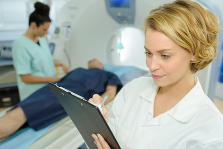 female doctor checking the report on clipboard at hospital