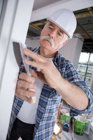 builder using device on wallの写真素材