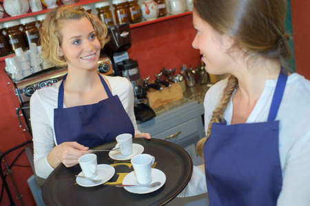 waitress serving cup of drinksの写真素材