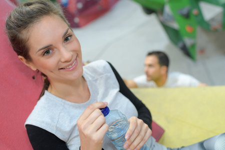 healthy woman drinking water after workout