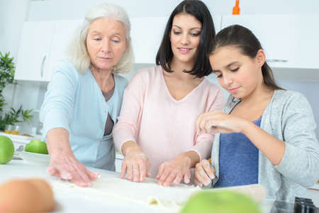 happy family of three generations cooking togetherの写真素材